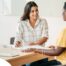 A woman smiles while being interviewed representing how well a caregiver interview can go when good questions are asked.