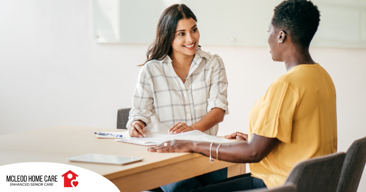 A woman smiles while being interviewed representing how well a caregiver interview can go when good questions are asked.